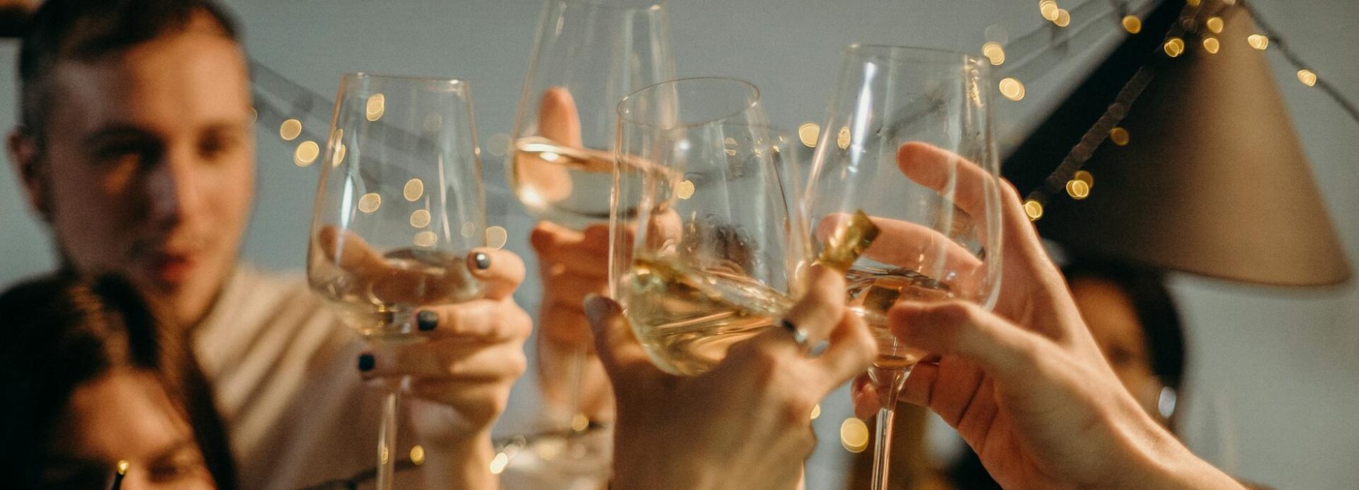 selective focus photography of several people cheering wine glasses